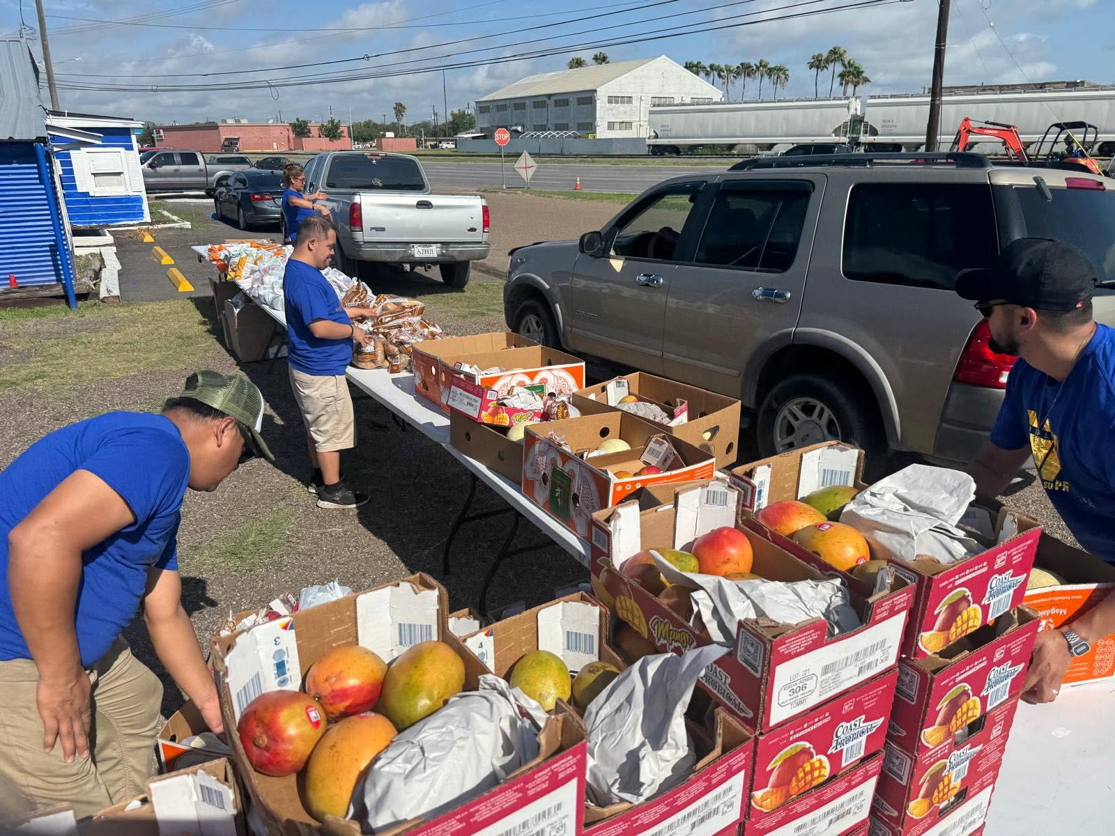 Hearts 4Kids volunteers preparing fresh produce and groceries for a Rio Grande Valley food distribution